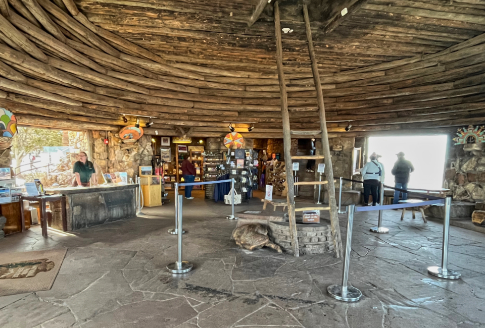 Circular building interior with ladder in middle and people and furniture