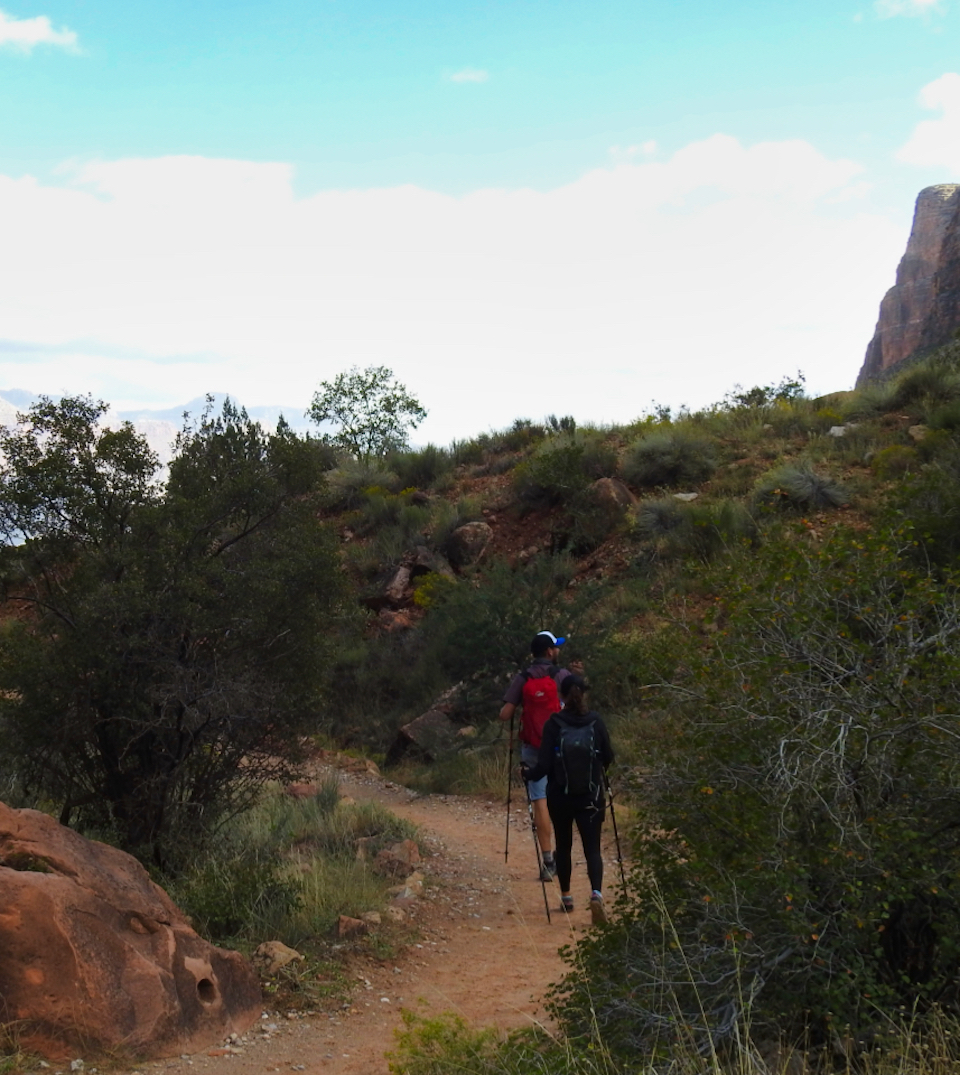Tractor and building materials with tower and cable, mountains in background