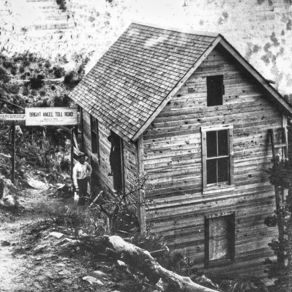 Trail and man next to wooden building