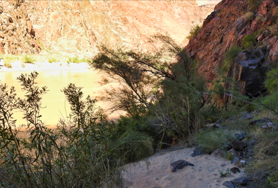 Men with boats on river with cliffs