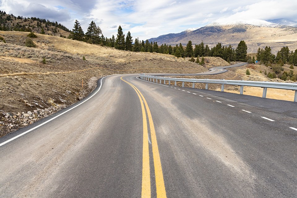 Single land dirt road with dump trucks