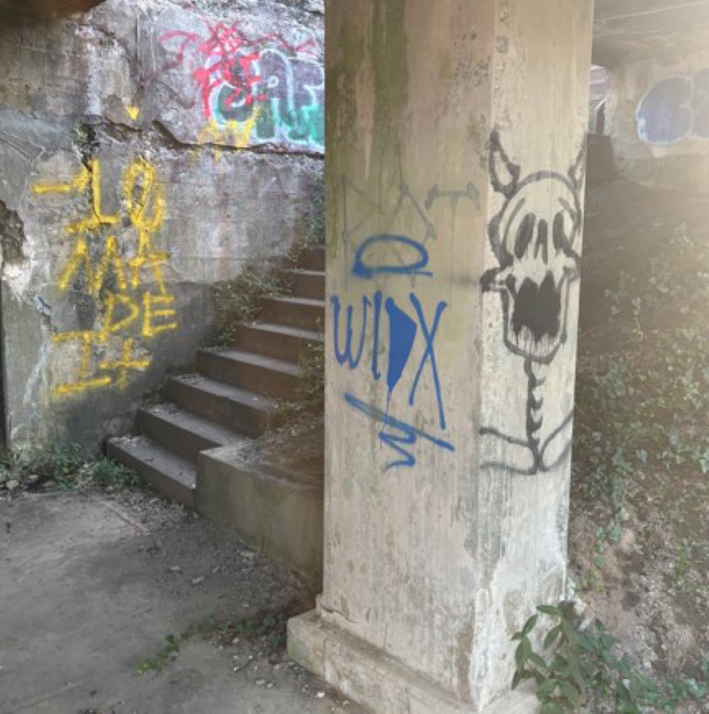 A pillar and stairs covered in graffiti