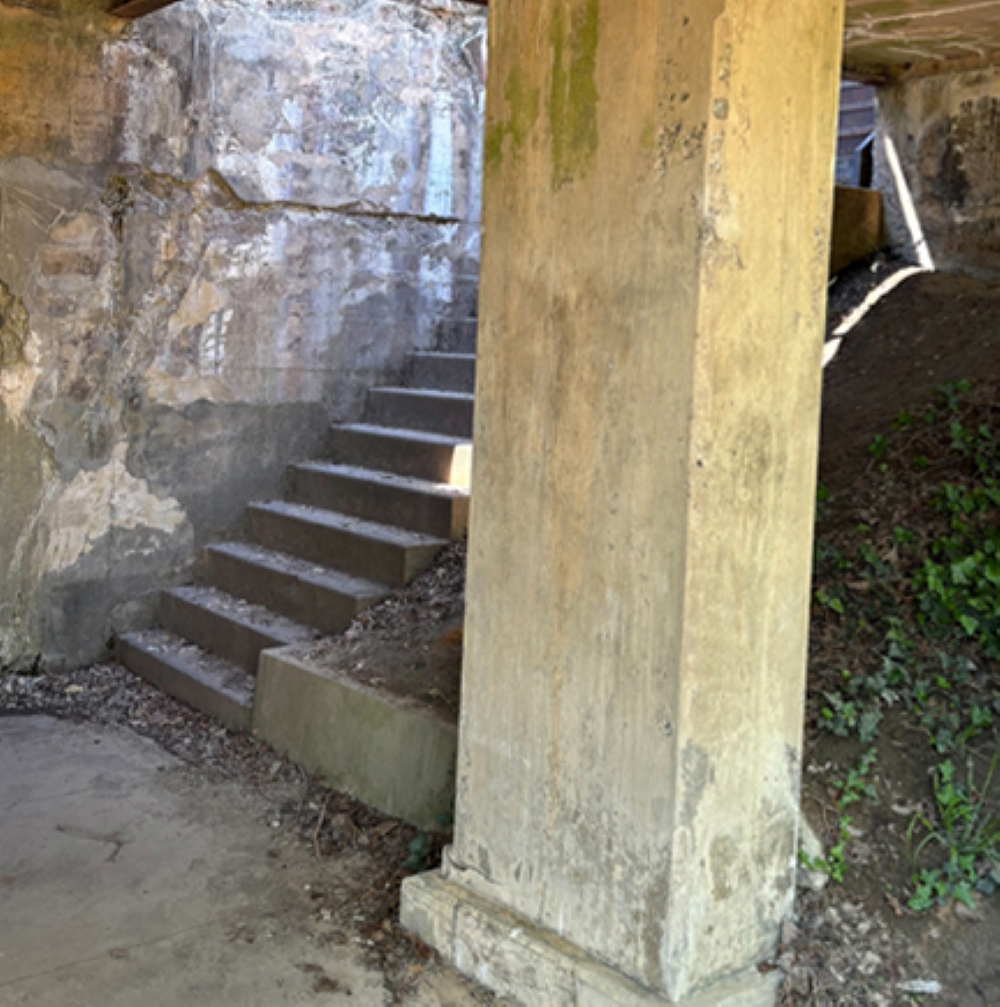 A pillar and stairs covered in graffiti