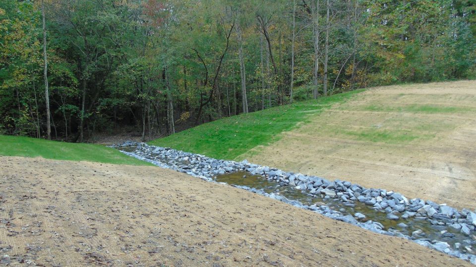 A large sinkhole in a grassy lawn