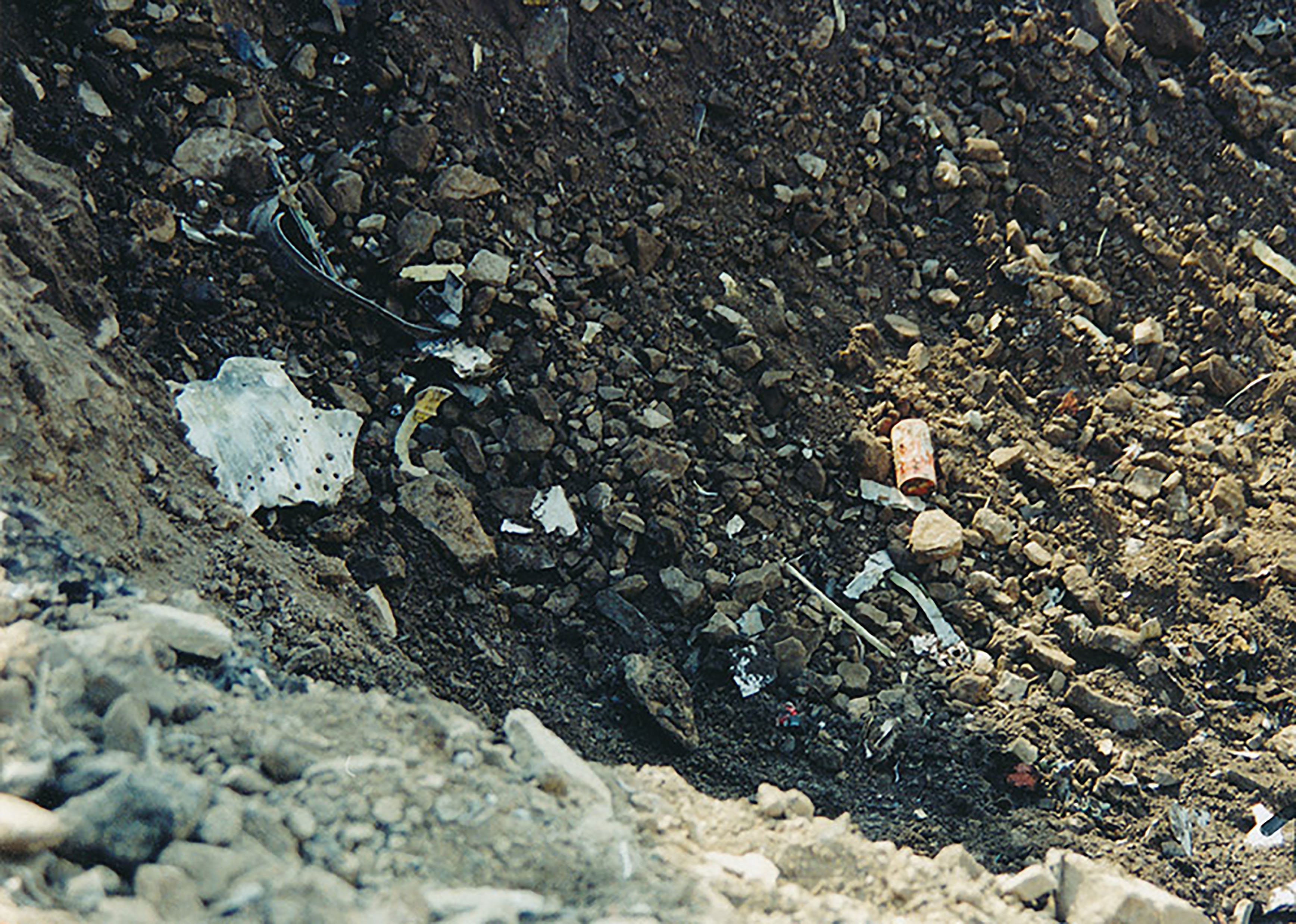 Debris, including the Flight Data Recorder is scattered near the crash site of Flight 93