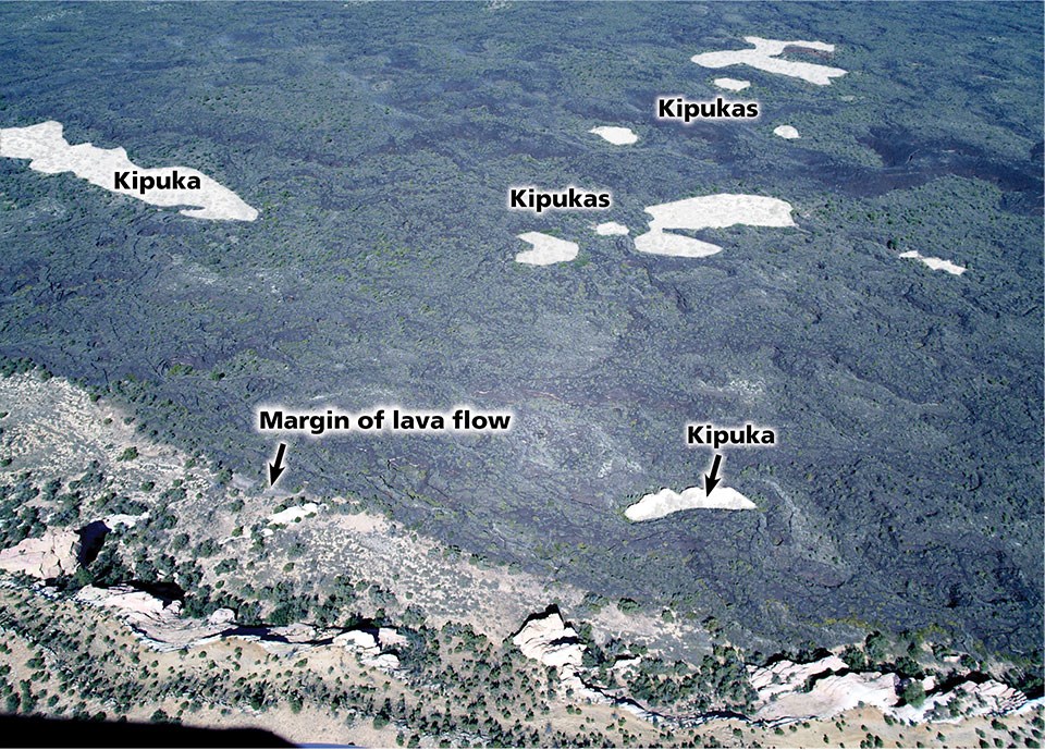 aerial photo of landscape with lava flow with small areas in the field not covered by lava