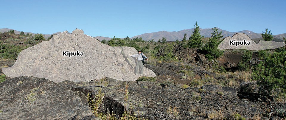 photo of a person standing in a rough lava field next to a raised blocky ridge