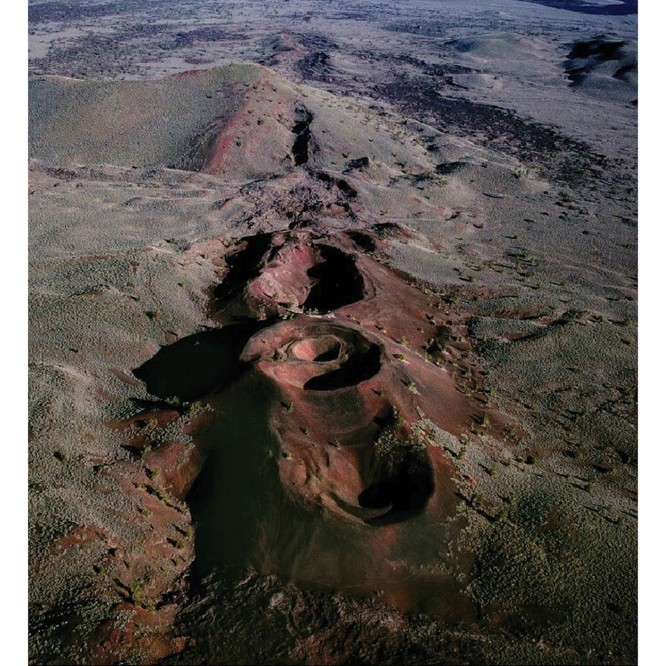 Oblique aerial photograph of a line of volcanic craters.