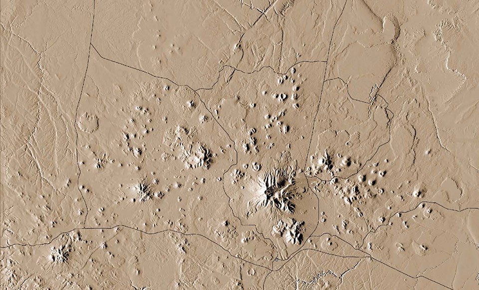 An aerial image of an area of the earth's surface showing several volcanic cones.