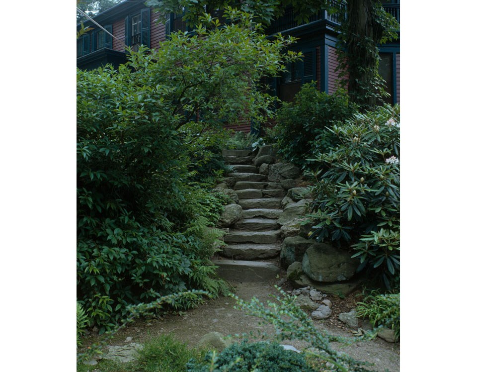 Gently-curving stone steps lead toward a two-story house, 1933.