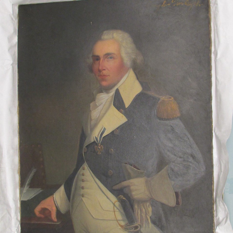 A dusty looking portrait of an older man in a Continental soldier's uniform. There is no frame.