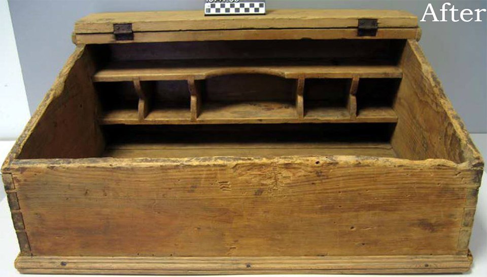 A wooden, boxy item that has a rough and faded surface.
