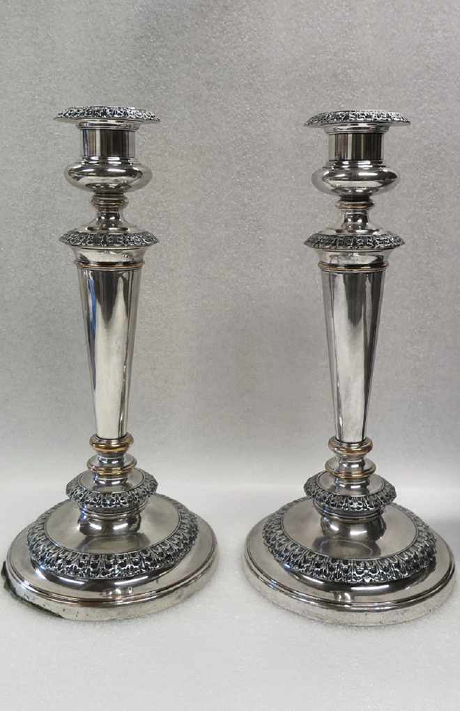 Two dark grey tarnished silver candlesticks.