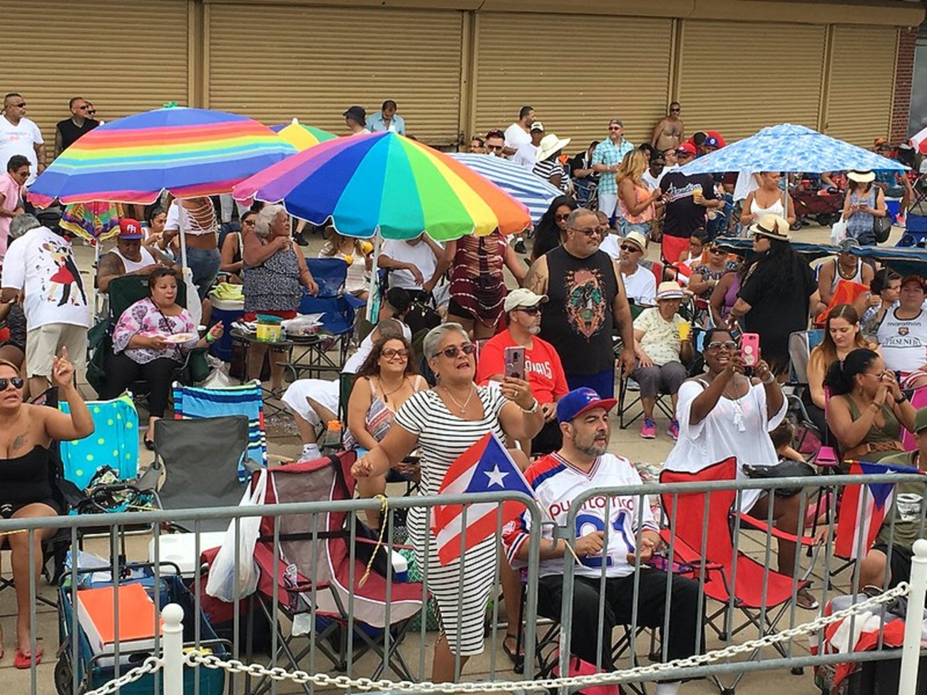 People in a crowd holding puerto rican memorabilia.