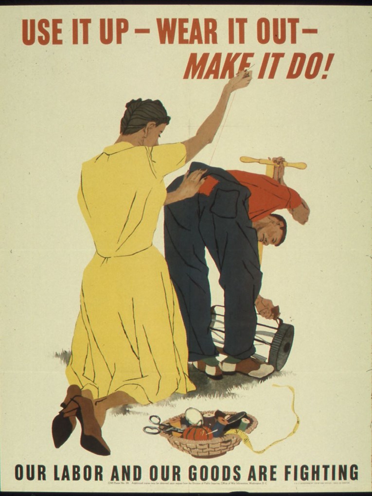 A man bends over to oil a lawnmower while a woman sews a patch on the back of his pants. A basket of sewing supplies is on the grass. He wears a red shirt, blue pants, and saddle shoes. She wears a bright yellow dress and brown high-heeled shoes.