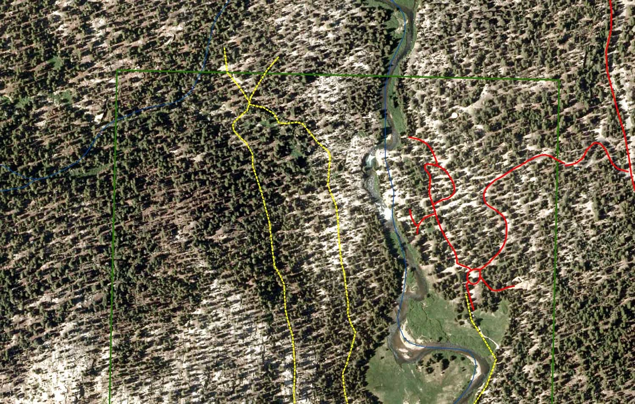 The pre-blowdown aerial image shows a meadow and river channel and forested areas on either side of the meadow.Lines representing roads and trails are shown.