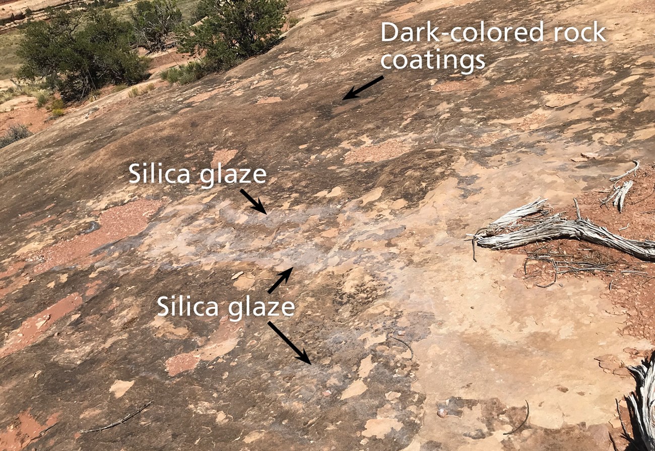 Photo of a rock surface with dark patches and text "Silica glaze".