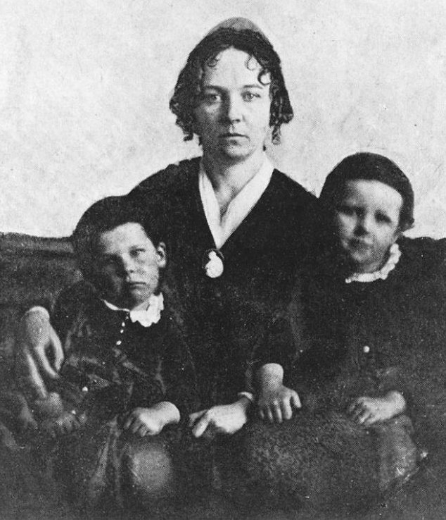 A woman seated with her two sons A woman seated with her two sons