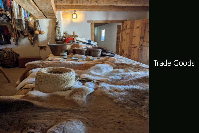 Photo of Trade Room counter with furs, string, kettles, beads, and blankets