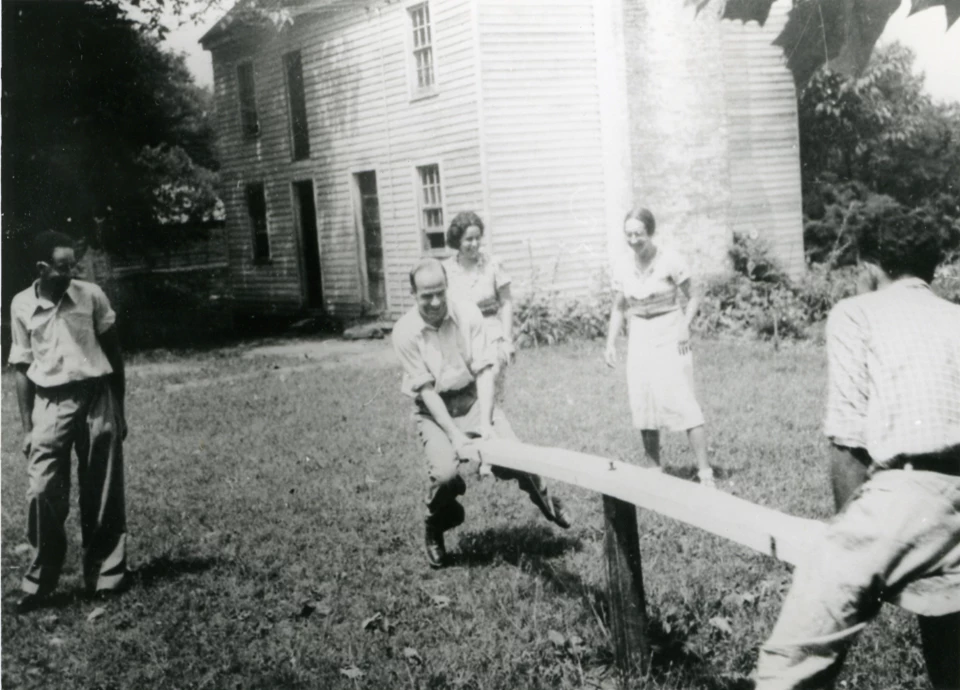 Image of Hyde Park's main house. The structure is a mix of Greek Revival and Federal style architecture. The earliest part of the house is brick, with white wood-paneled additions visible in the picture.