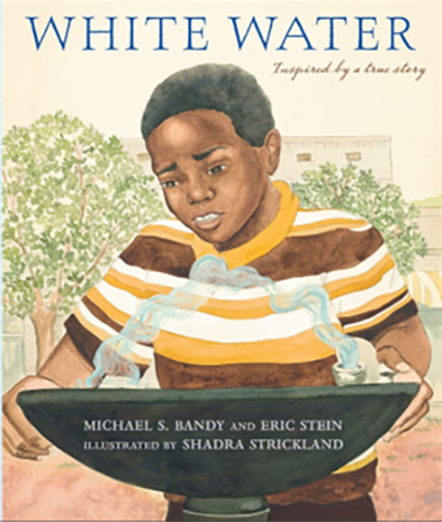 An African American boy drinks from a water fountain. An African American boy drinks from a water fountain.
