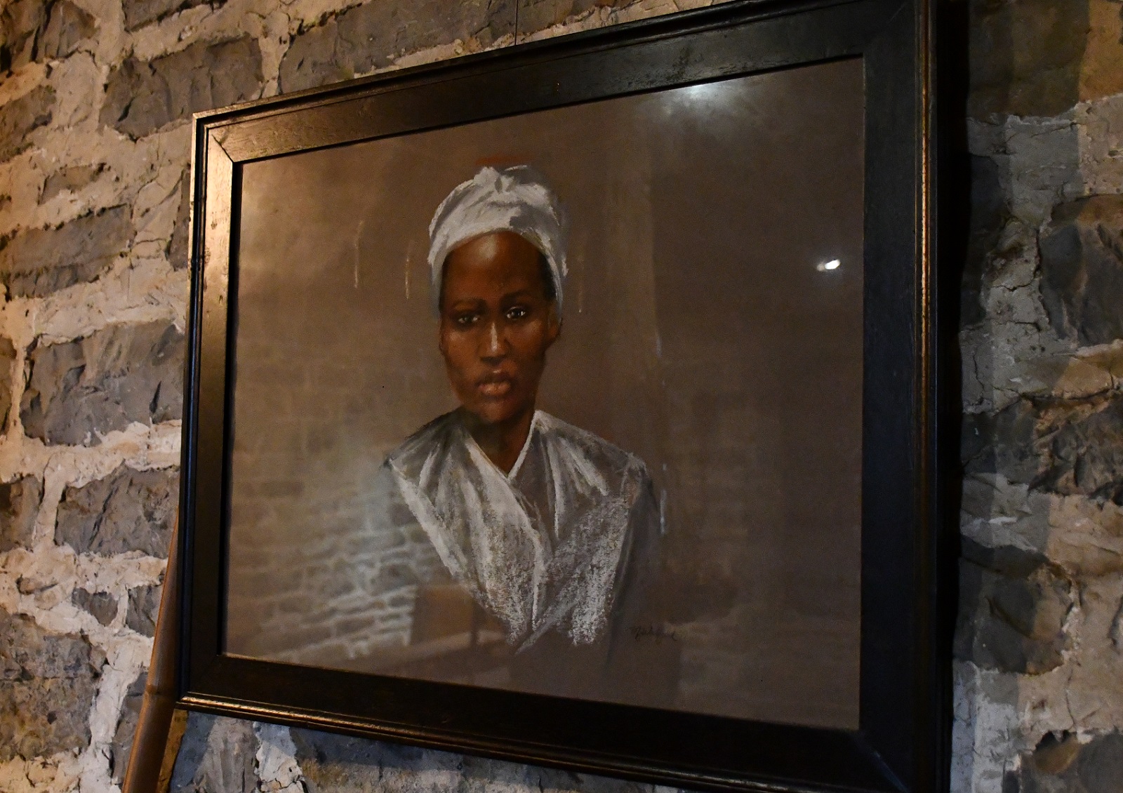Framed color sketch of a black woman, with a white head covering and white clothing. Framed color sketch of a black woman, with a white head covering and white clothing.