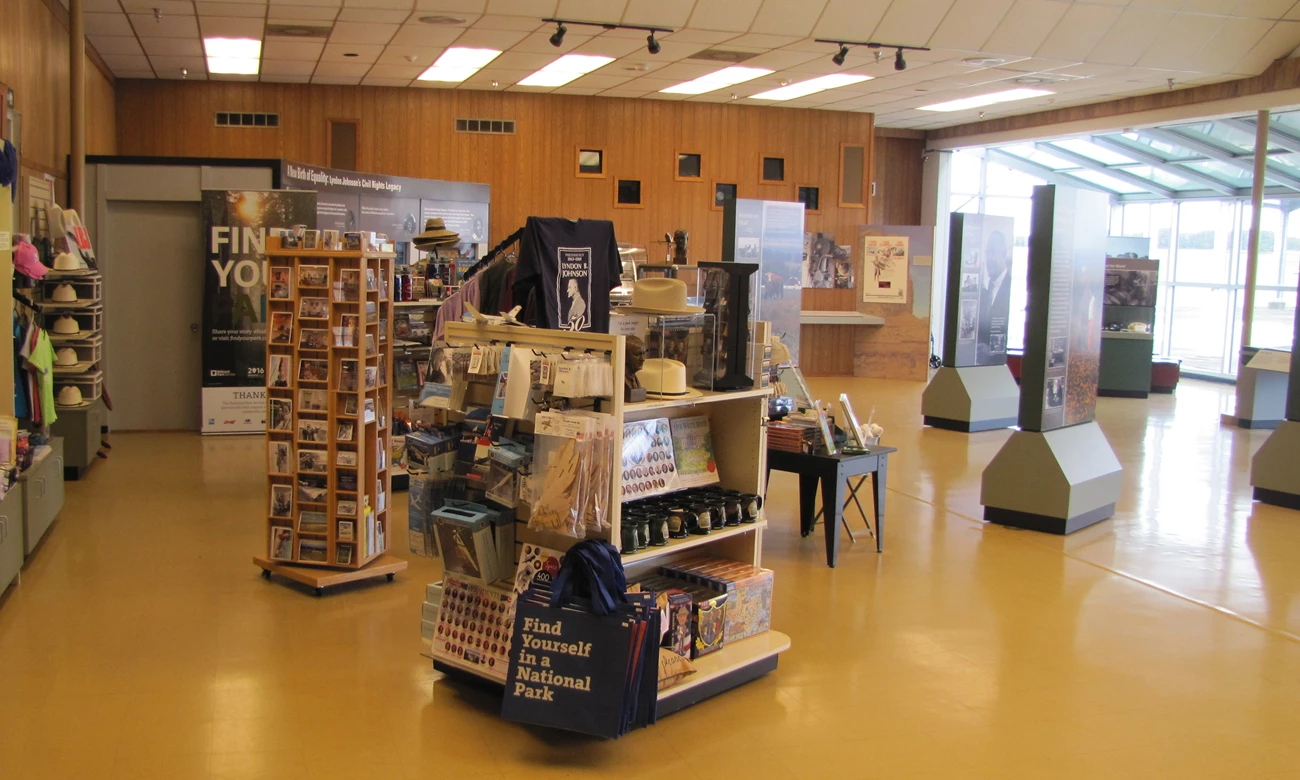 A room containing bookstore shelves and exhibit panels.