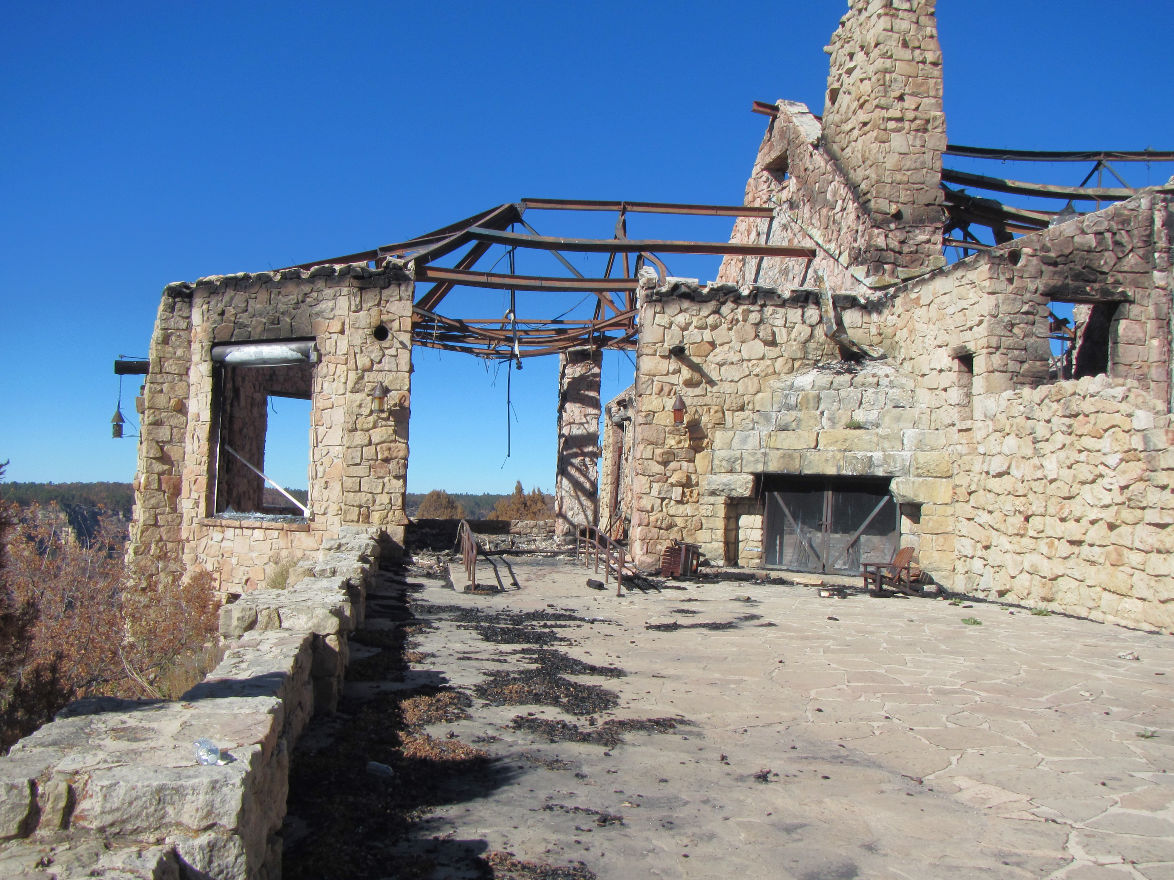 The Grand Canyon Lodge veranda post Dragon Bravo Fire showing standing metal beams and rock
