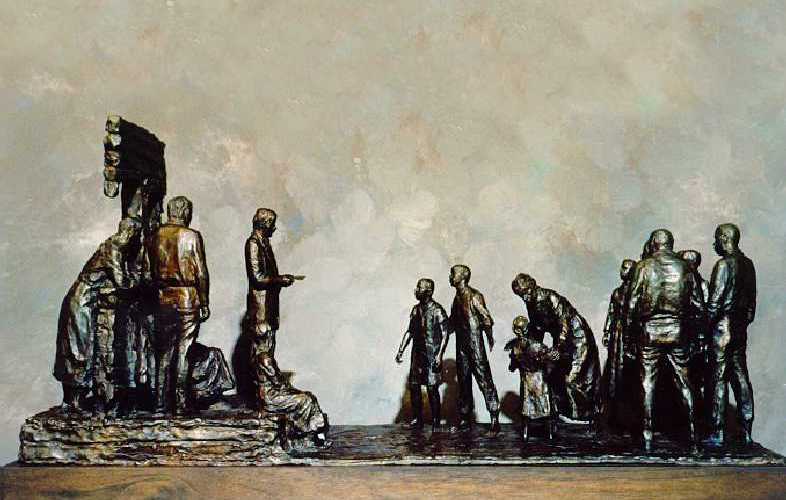 A statue of a group of figures facing a uniformed figure reading from a document. 