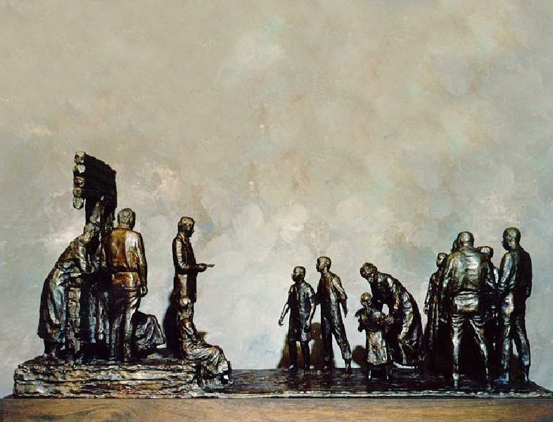 A statue of a group of figures facing a uniformed figure reading from a document. 