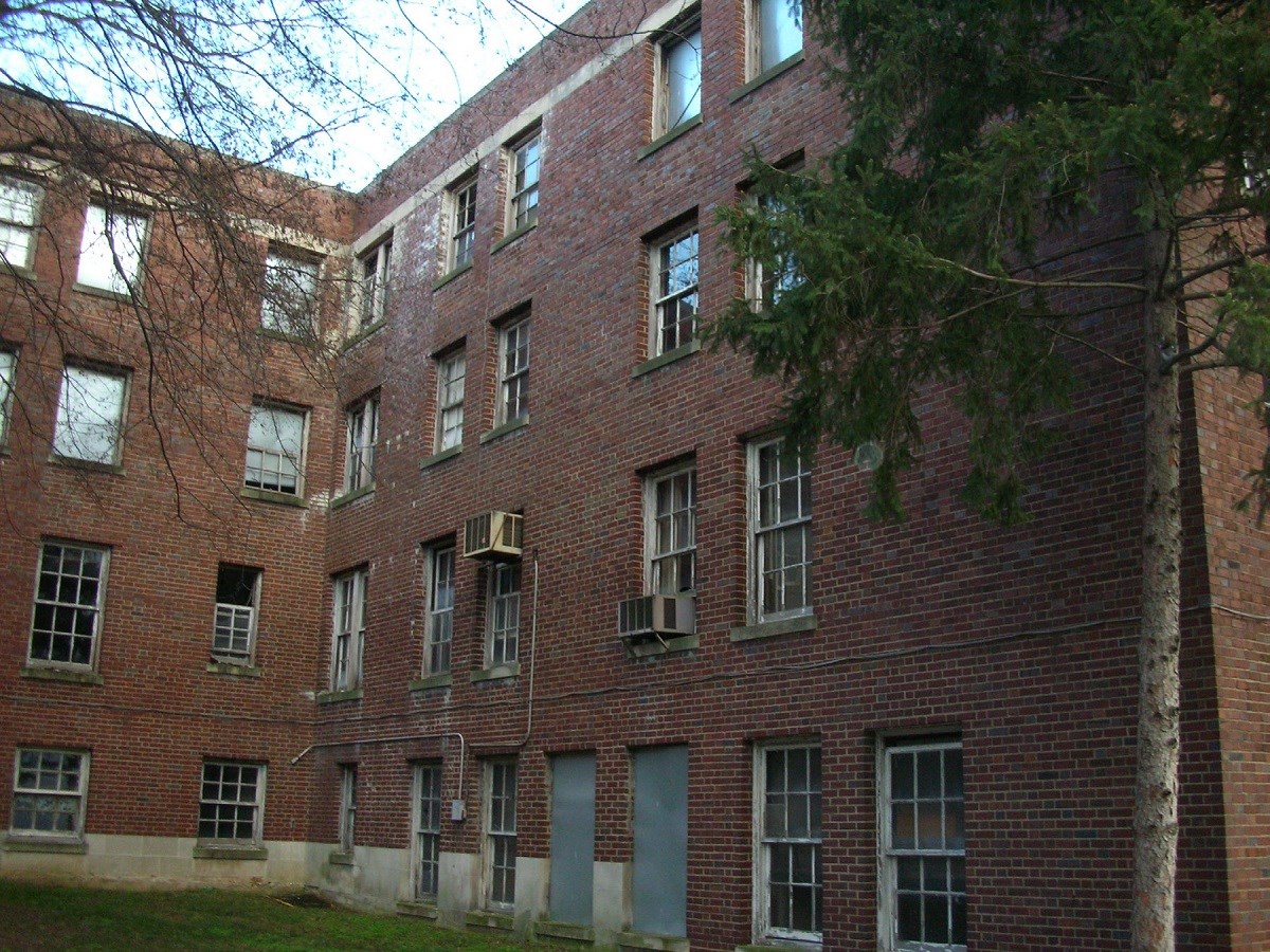 Internal corner of brick building with some covered windows