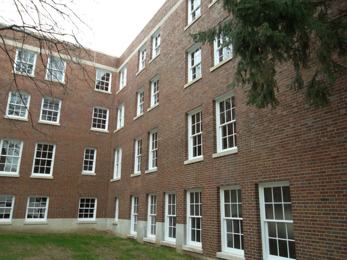 Internal corner of brick building with some covered windows