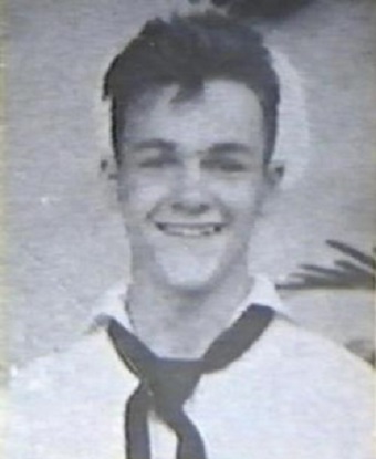 Black and white photo of a young man in a sailor suit.