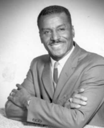 B&W portrait of Mr. Shuttlesworth seated with arms crossed wearing suit B&W portrait of Mr. Shuttlesworth seated with arms crossed wearing suit
