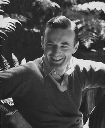 A 1941 photo depicts a young man in a sweater posing casually outdoors. A 1941 photo depicts a young man in a sweater posing casually outdoors.