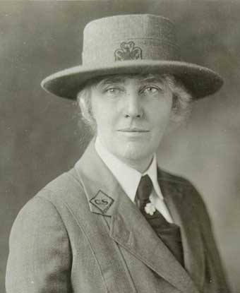 A 1925 portrait photo depicts a 51 year old woman in a girl scouts uniform. A 1925 portrait photo depicts a 51 year old woman in a girl scouts uniform.