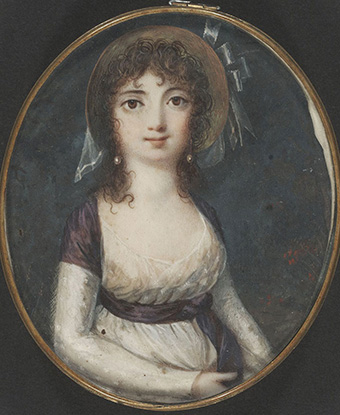 Color image of a waist-length portrait of a young woman with large eyes and dark hair.