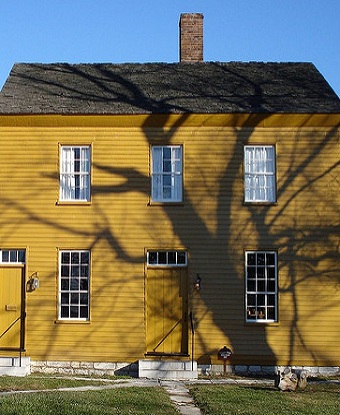 yellow clapboard structure with two entrances