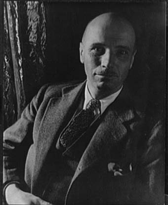 A black and white photo of Rockwell Kent, wearing a suit. 