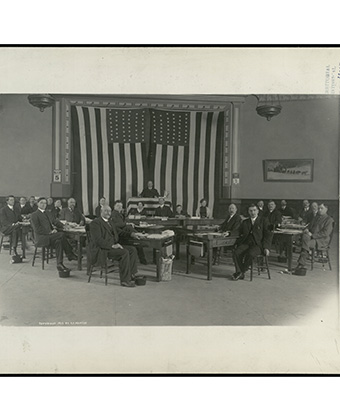 Group of men seated, facing the camera. Courtesy Alaska State Library.