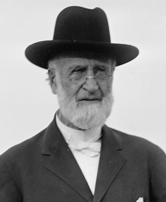 A man wearing a hat and suit