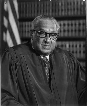 Portrait photograph of Chief Justice Thurgood Marshall, wearing judicial robe, seated, facing front.