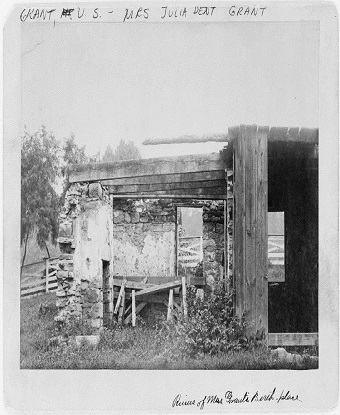 Wood and stone outbuilding about 20 feet wide, 15 feet high.