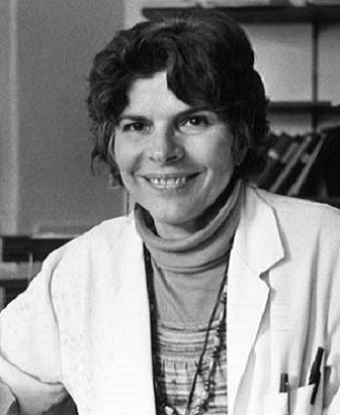 Head and shoulders portrait of a woman wearing a lab coat.