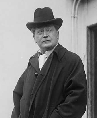 A man wearing an overcoat and hat.
