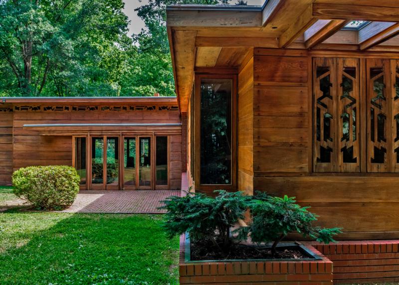 A red-brown wood slatted house built with natural resources