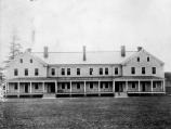Black and white photograph of large barracks building