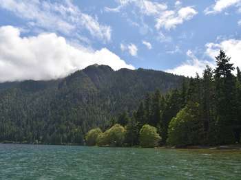 A lake with mountains rising beyond the shore.