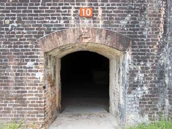 A tunnel leads through a brick wall