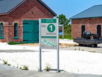 Metal sign with green and white text and the number,